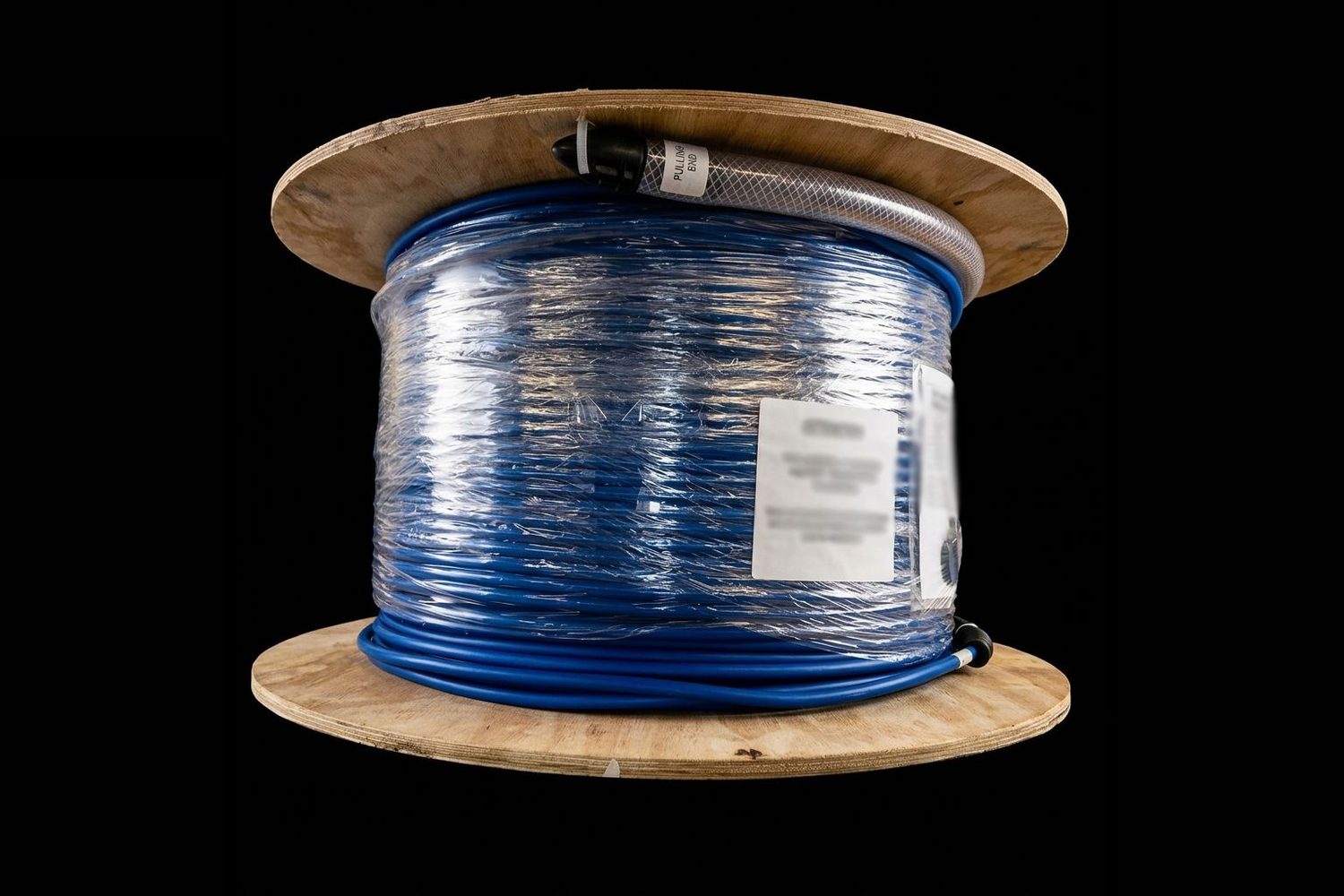 Blue pre-terminated multicore fibre assembly wound on a wooden drum