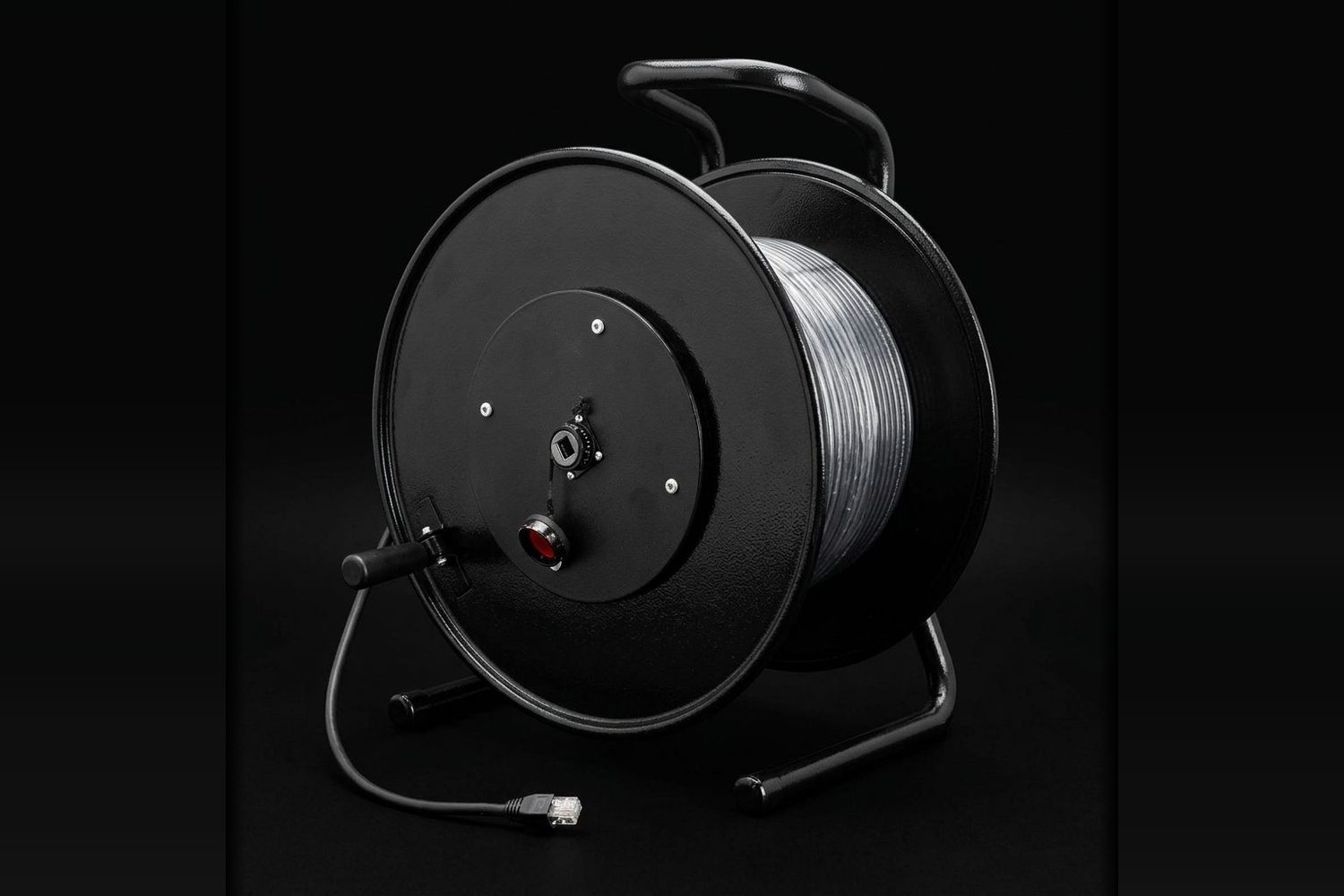 Tactical copper cable assembly wound on a black deploy reel