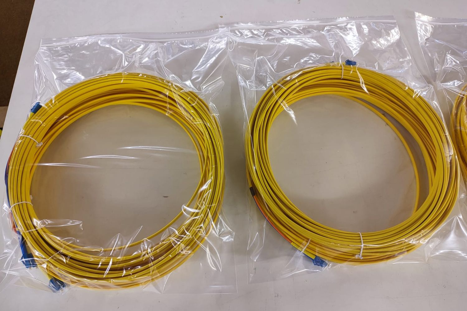 Yellow singlemode fibre pigtails, coiled and bagged in bundles