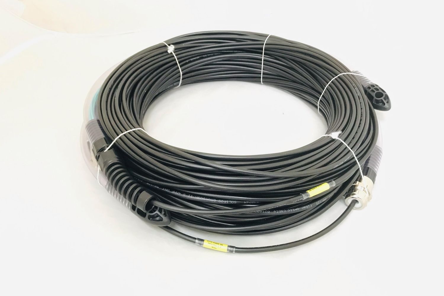 Long coil of black tactical copper cable with ruggedised connectors at each end
