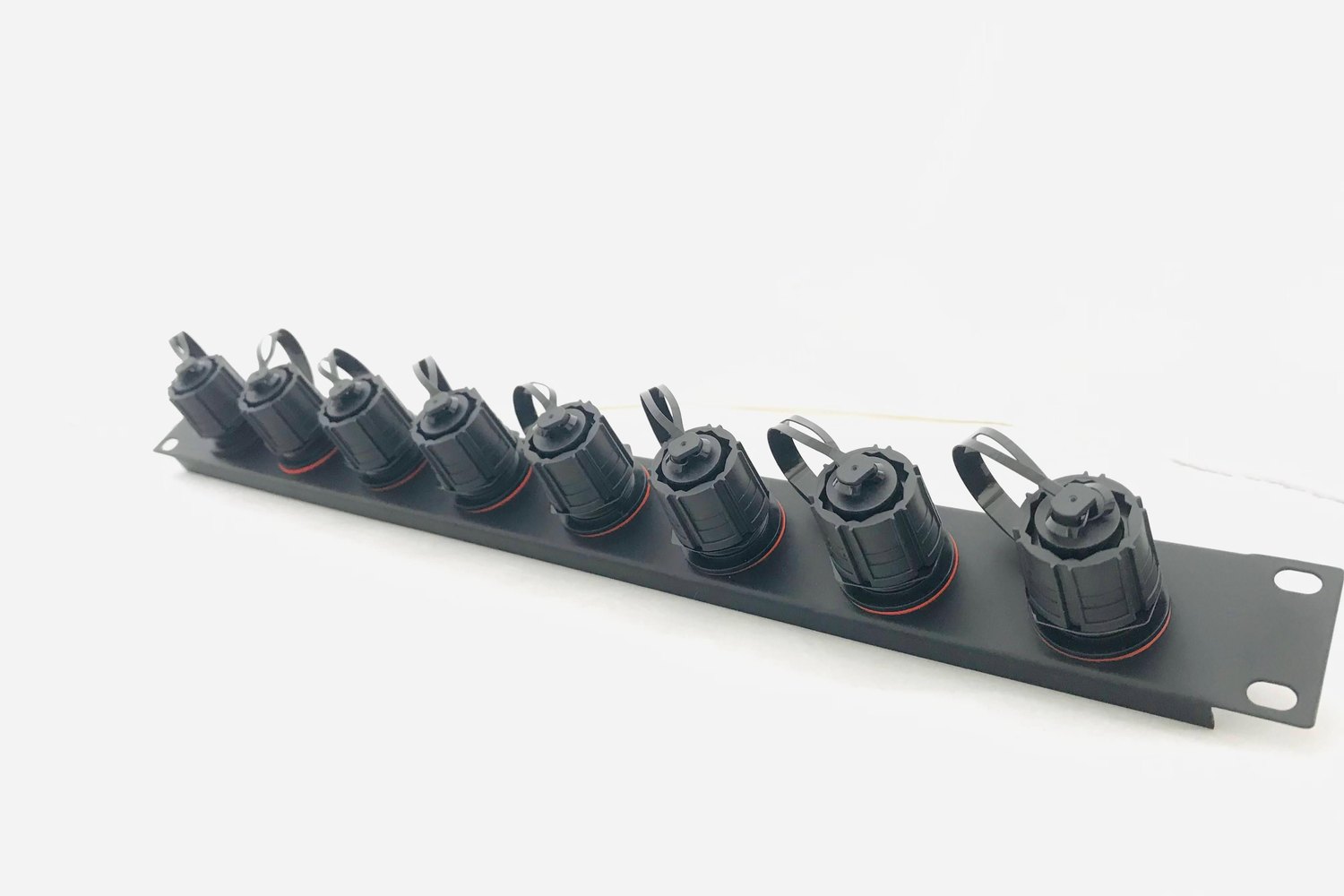 Black rack-mount panel with eight IP Pro bulkhead fibre connectors and tethered dust caps
